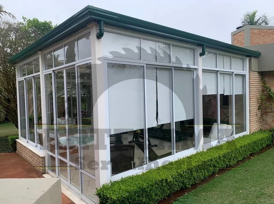 Fechamento de ambiente residencial com esquadrias brancas de alumínio e vidro